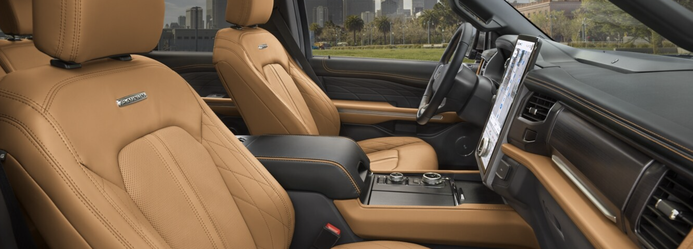 The dashboard of a Ford Expedition, showcasing its large central touchscreen with navigation and entertainment options, as well as physical controls for climate and audio settings.