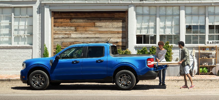 A Ford Mustang Mach-E highlighting its all-wheel-drive system and winter tires as it confidently navigates a snowy landscape.