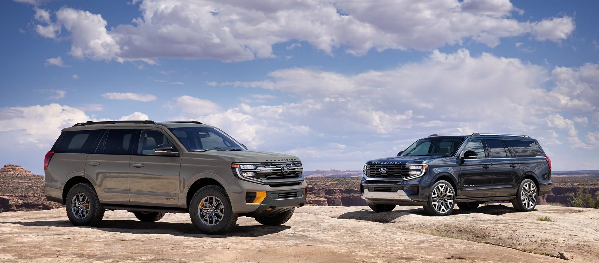 Two new 2026 Ford expeditions in Goodyear are parked facing inwards on the top of a red rocky landscape.