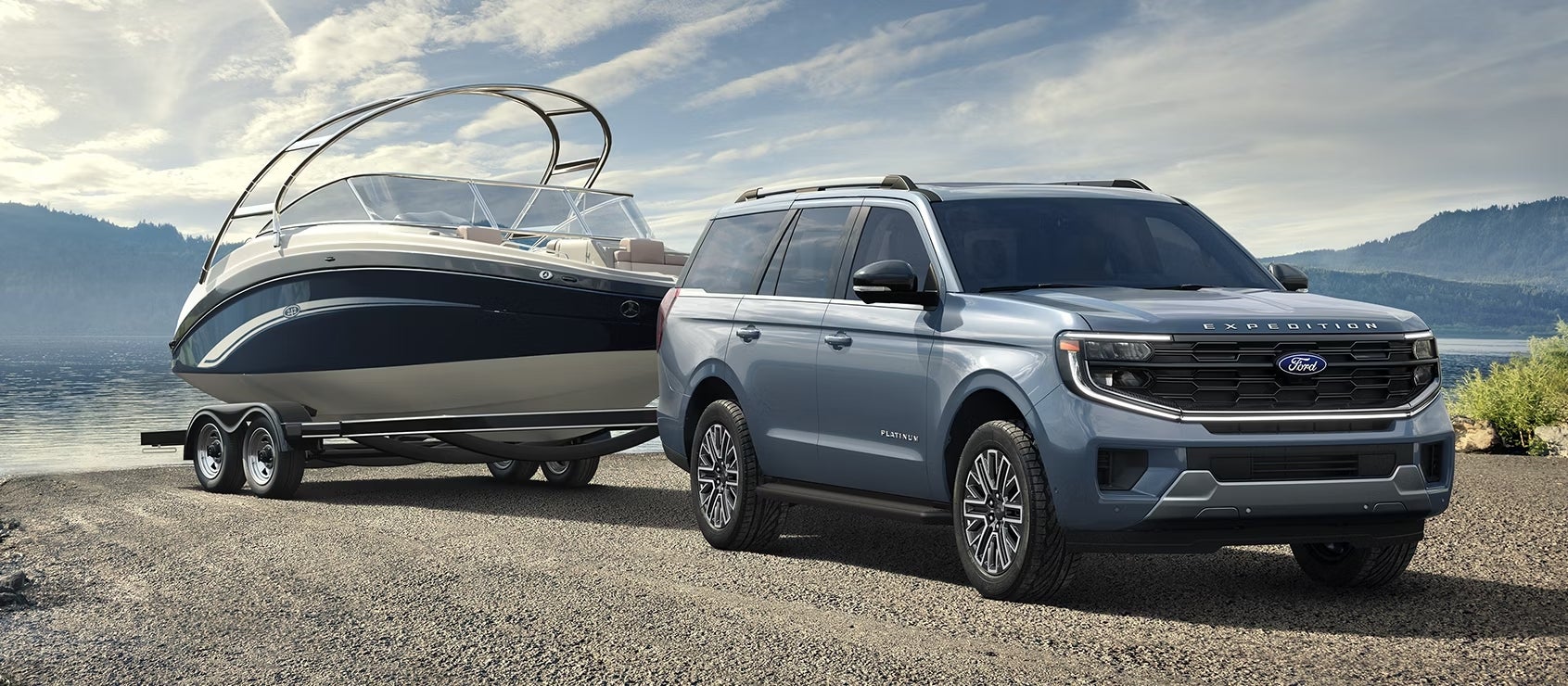 A blue new Ford Expedition in Phoenix drives towards the viewer to the right while towing a boat out of a lake.