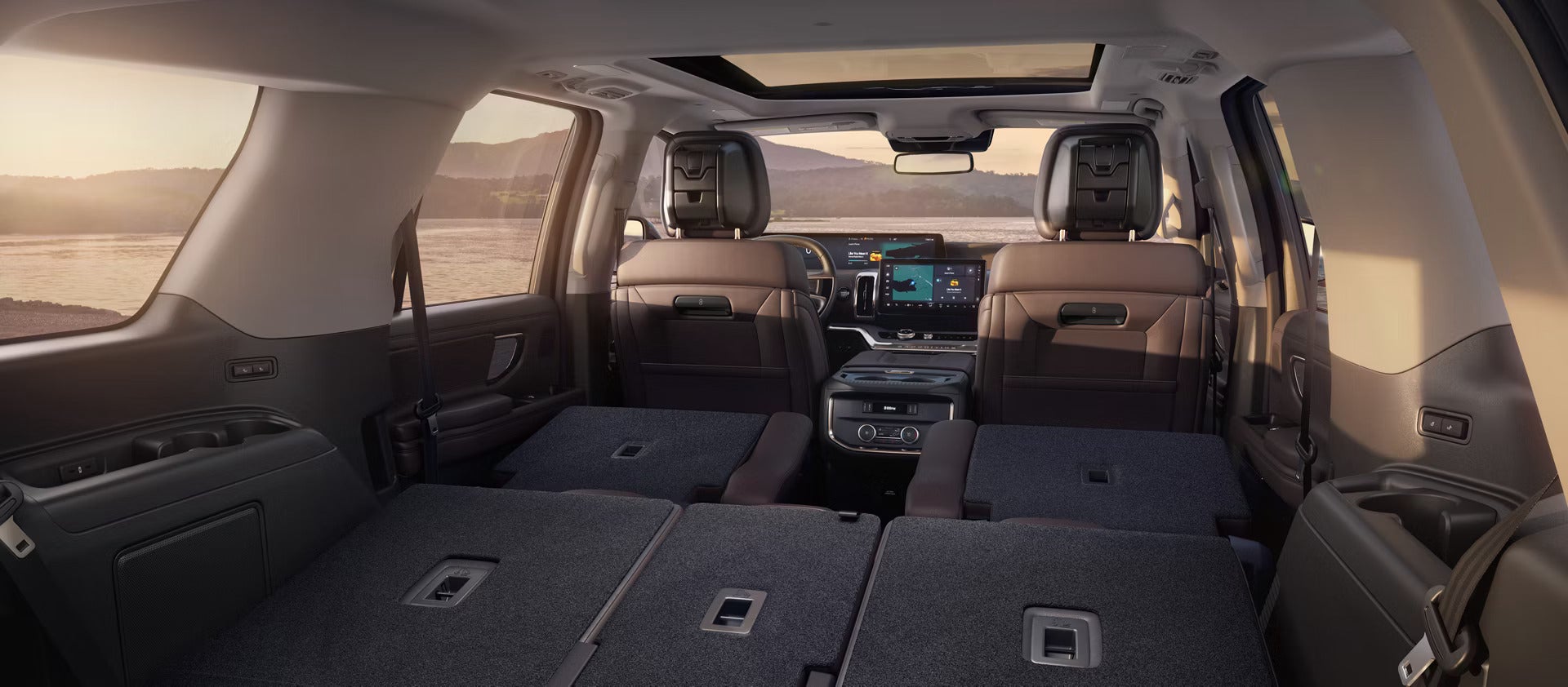 The interior of the new Ford Expedition in Goodyear is seen from the back looking forwards with all seats folded down and a desert environment is visible through the windows.