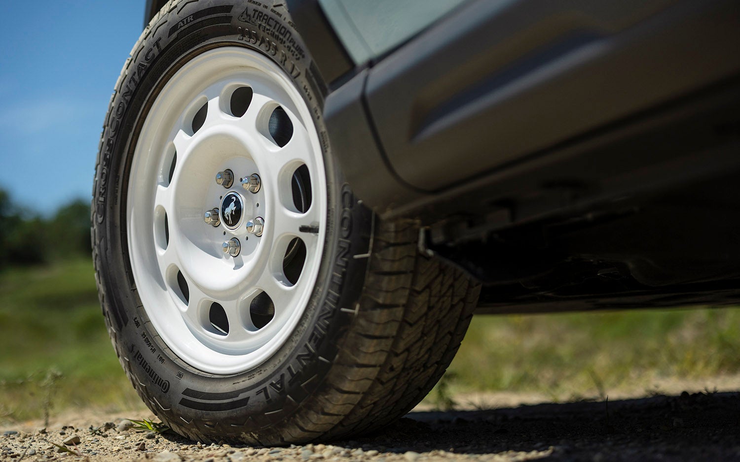 "Close-up view of a white wheel with a black tire on a Ford Bronco Sport."