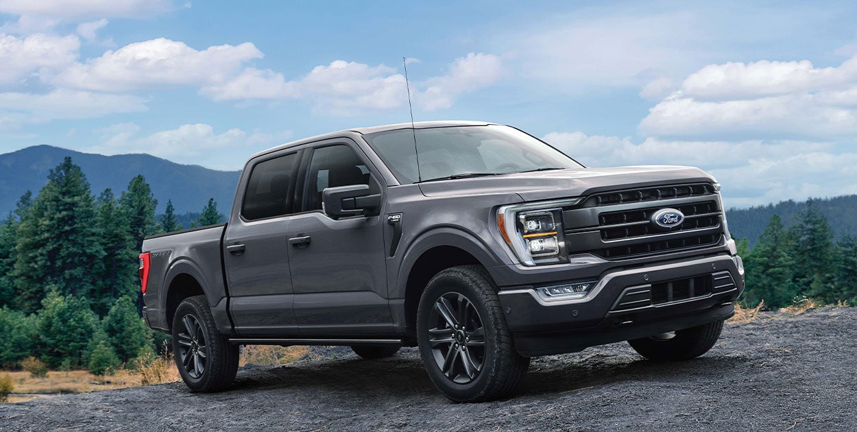 A Ford F-150 highlighting its Pro Power Onboard feature, which allows it to function as a mobile generator and power various electrical devices.