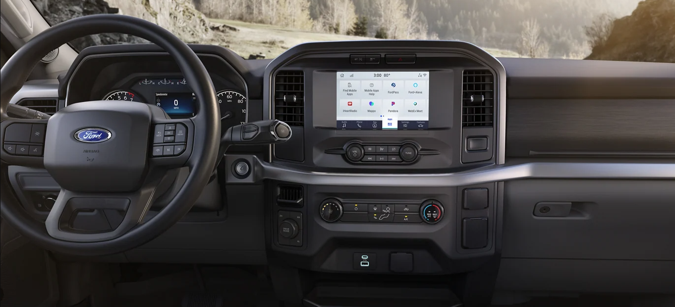 A Ford Expedition towing a boat on a highway.