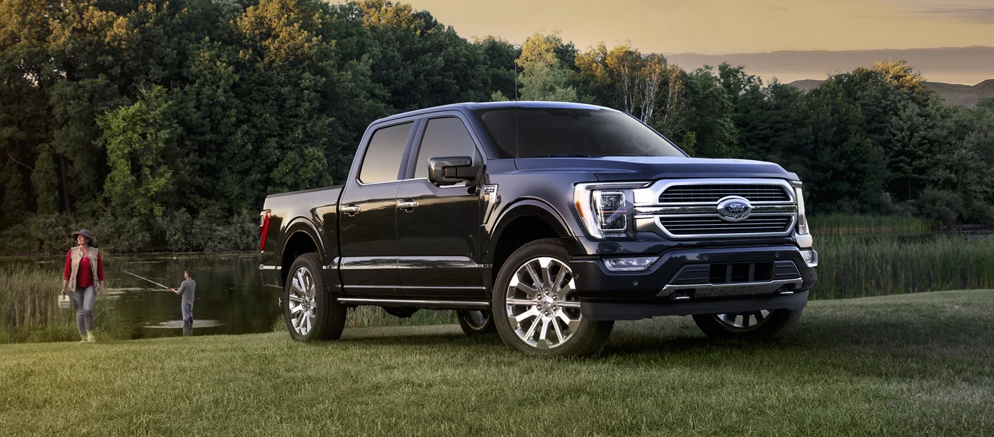 A red 2023 Ford Explorer driving on a scenic road.