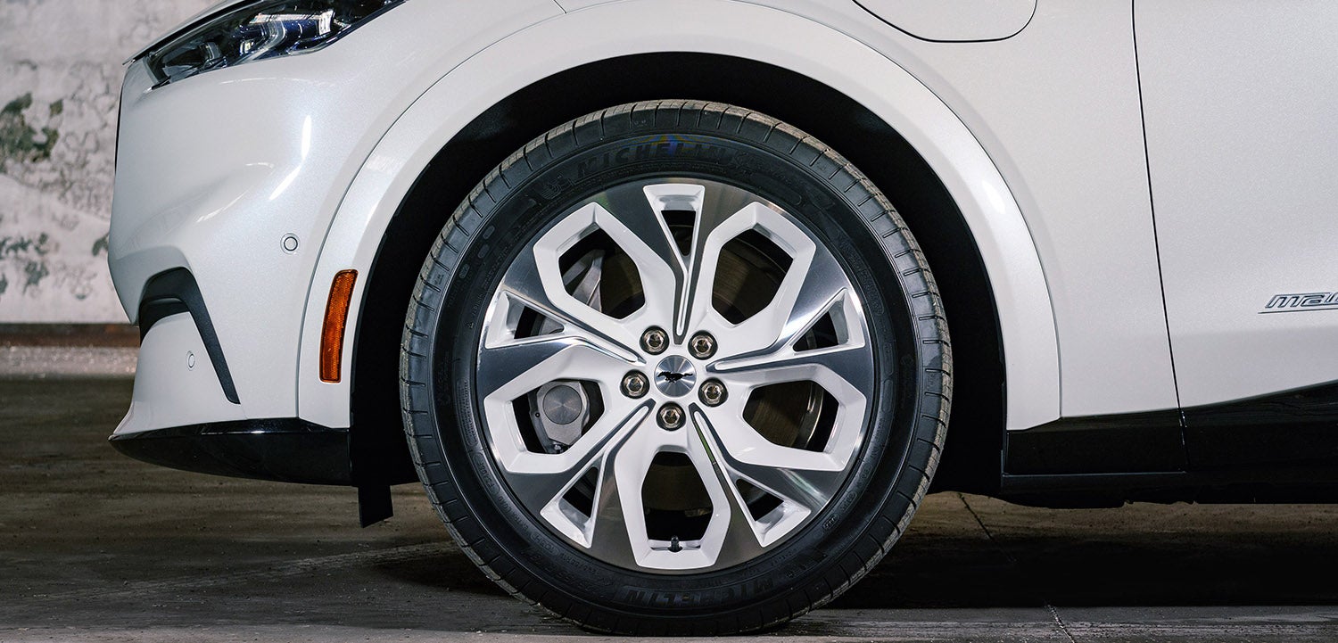 A blue Ford Explorer parked on a city street.